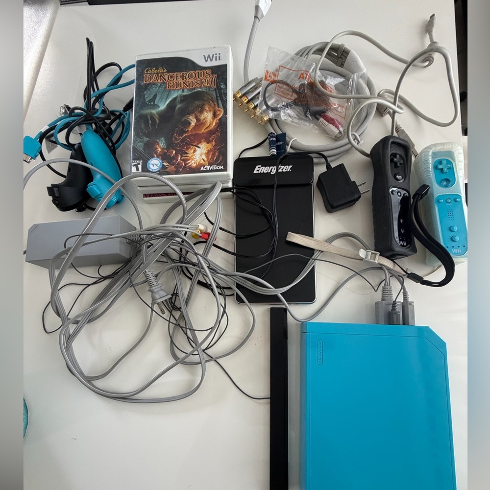 Nintendo Wii in Aqua Blue controllers, batt charger and games